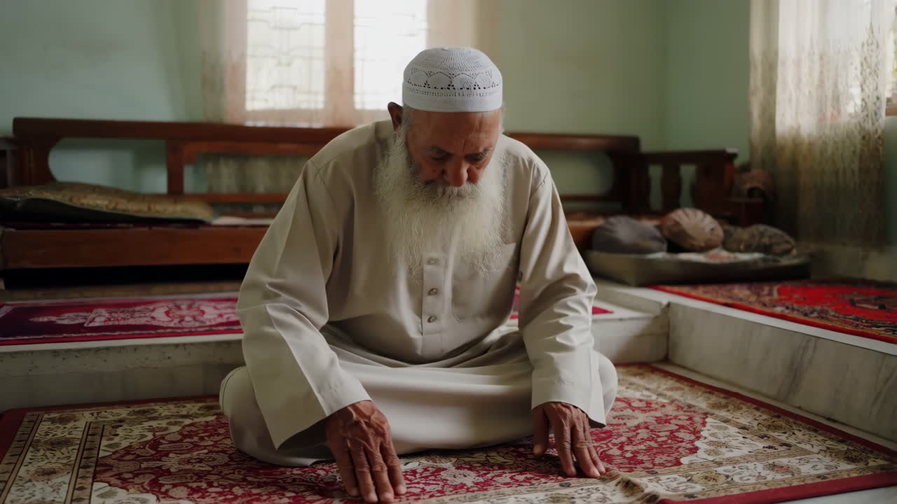 An elderly Muslim man praying indoors
