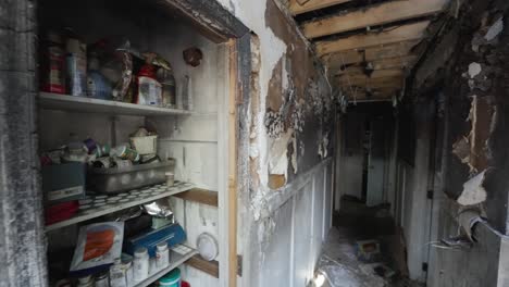 burnt hallway walls and pantry after a house fire with peeling paint