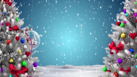 Two-christmas-trees-and-hanging-bauble-decorations-against-snow-falling-over-winter-landscape