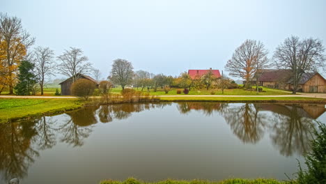 tranquil country lakeside farm at autumn season