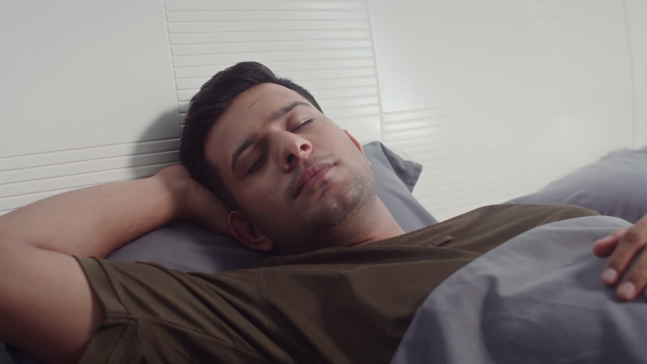 Man Sleeping in Cozy Bed