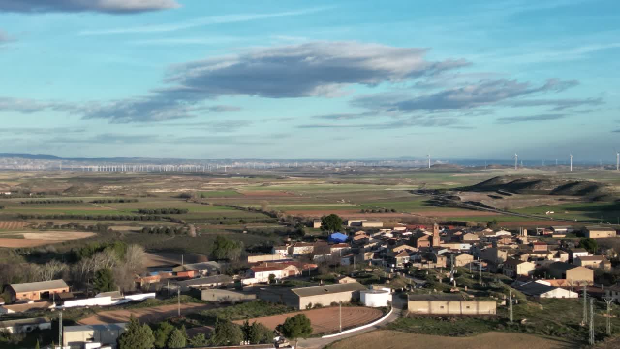Aerial view of Pozuelo de Aragón Spain with many wind turbines in the area.