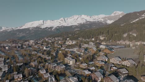 tilting aerial over alpine houses of beautiful rich mountain resort crans montana, switzerland