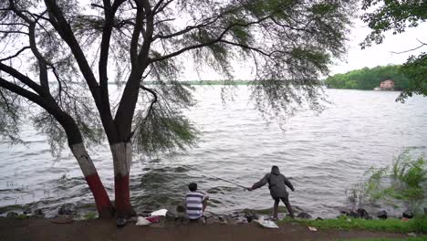 fisherman fishing by the lake