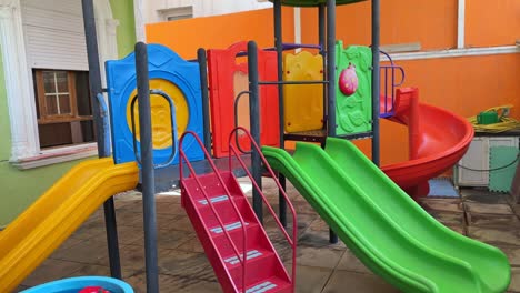 bright 4k video of a cheerful playground with colorful slides and structures. perfect for education, childhood, daycare, family, or outdoor recreation footage.