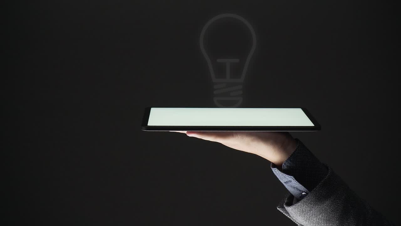 idea concept. a business person show a virtual light bulb on a tablet.