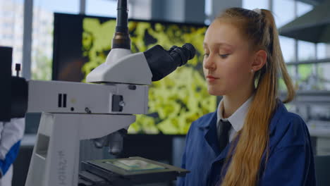 student using microscope in a science lab