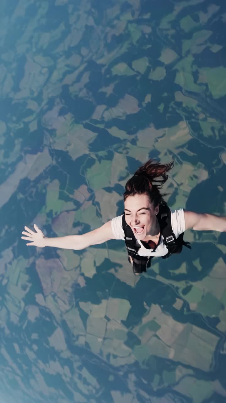 Aerial video still of a person skydiving, captured from a high-angle perspective