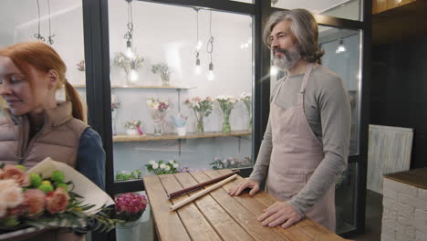 florist giving bouquet to customer