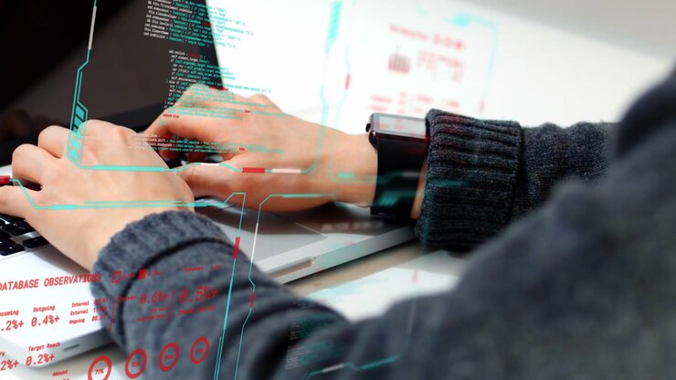Developer hands typing on laptop keys at desk, HUD graphics syncing with motion while writing code
