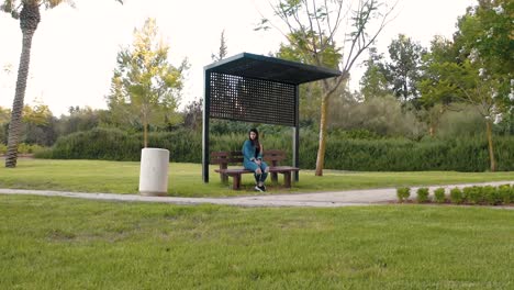 girl sits on a bench in the park