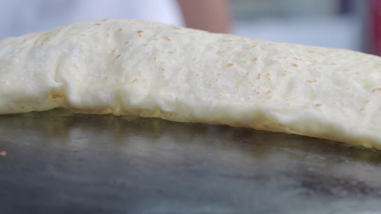 Close-Up of Flatbread Cooking on a Hot Griddle