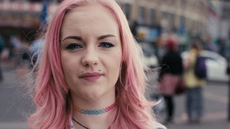 slow motion portrait of caucasian girl with pink hair smiling