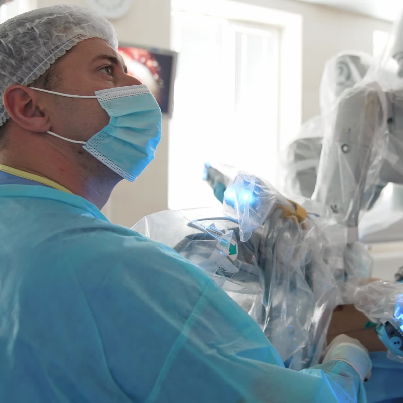 Handsome surgeon working with modern equipment. Hospital neurosurgery ward
