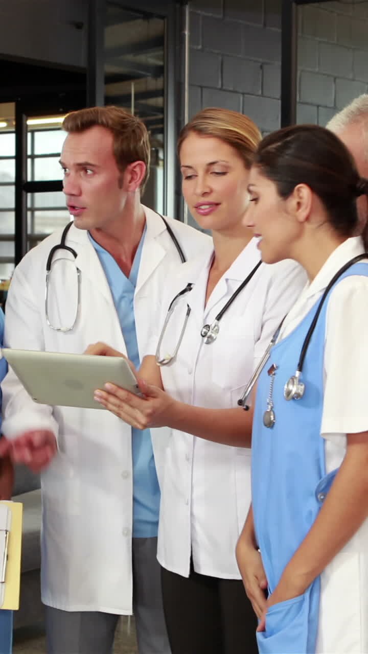 Doctors using tablet and talking