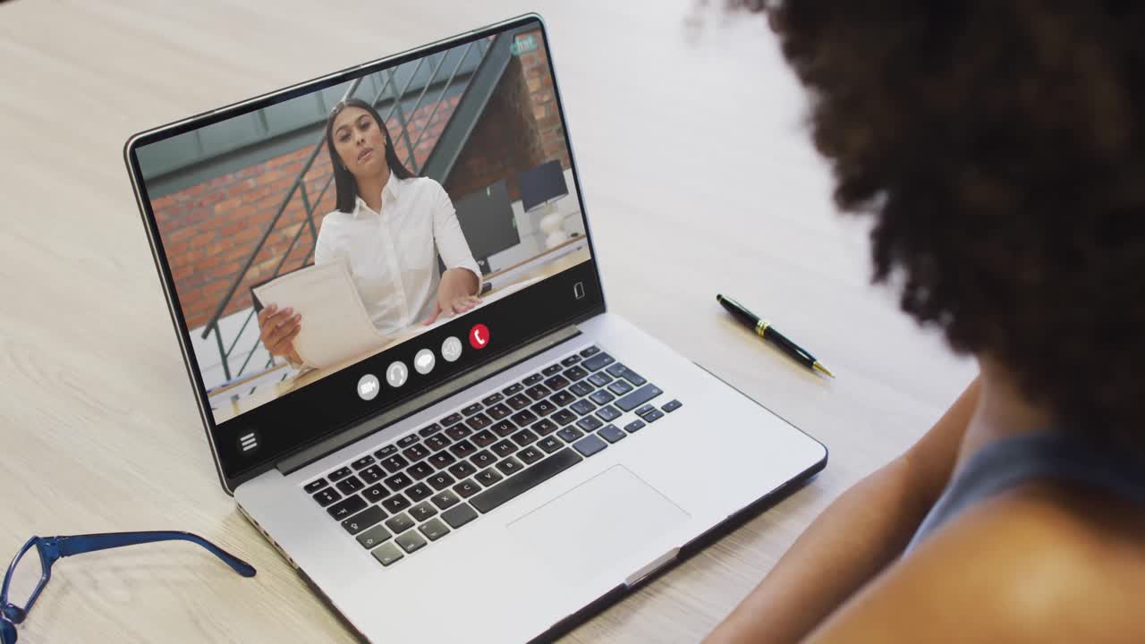 Animation of african american woman having video call on laptop