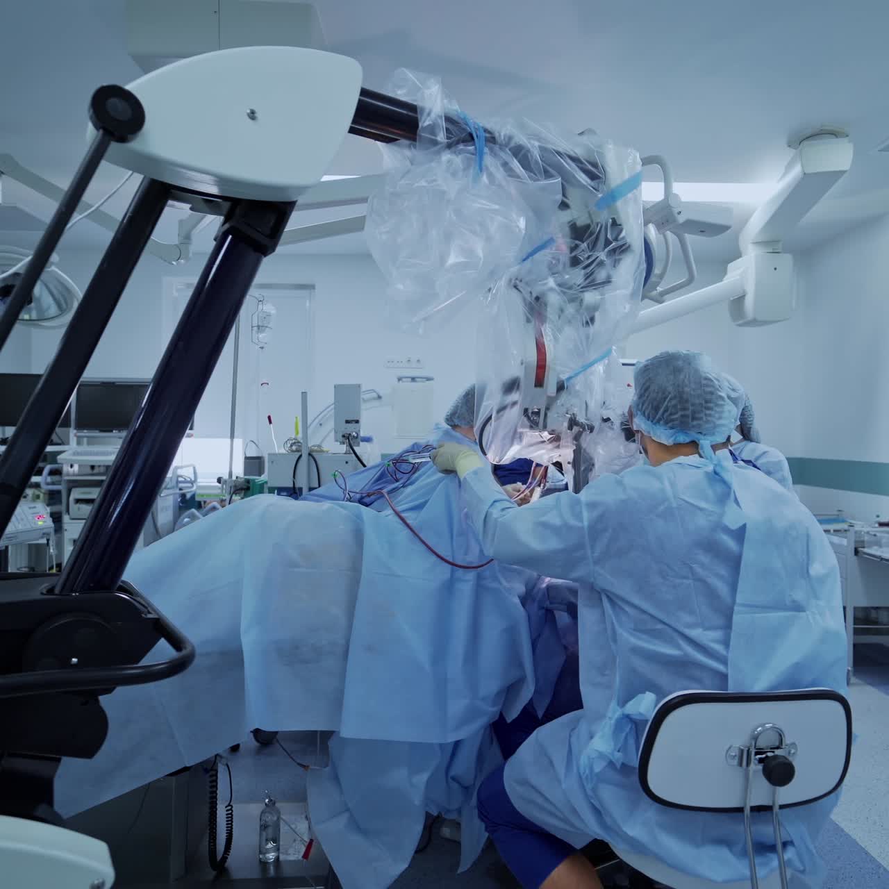 Medical team performing surgical operation in bright modern operating room. Modern equipment in operating room