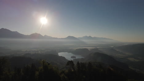 parallax shot showing lake bled in distance during sunset, aerial view