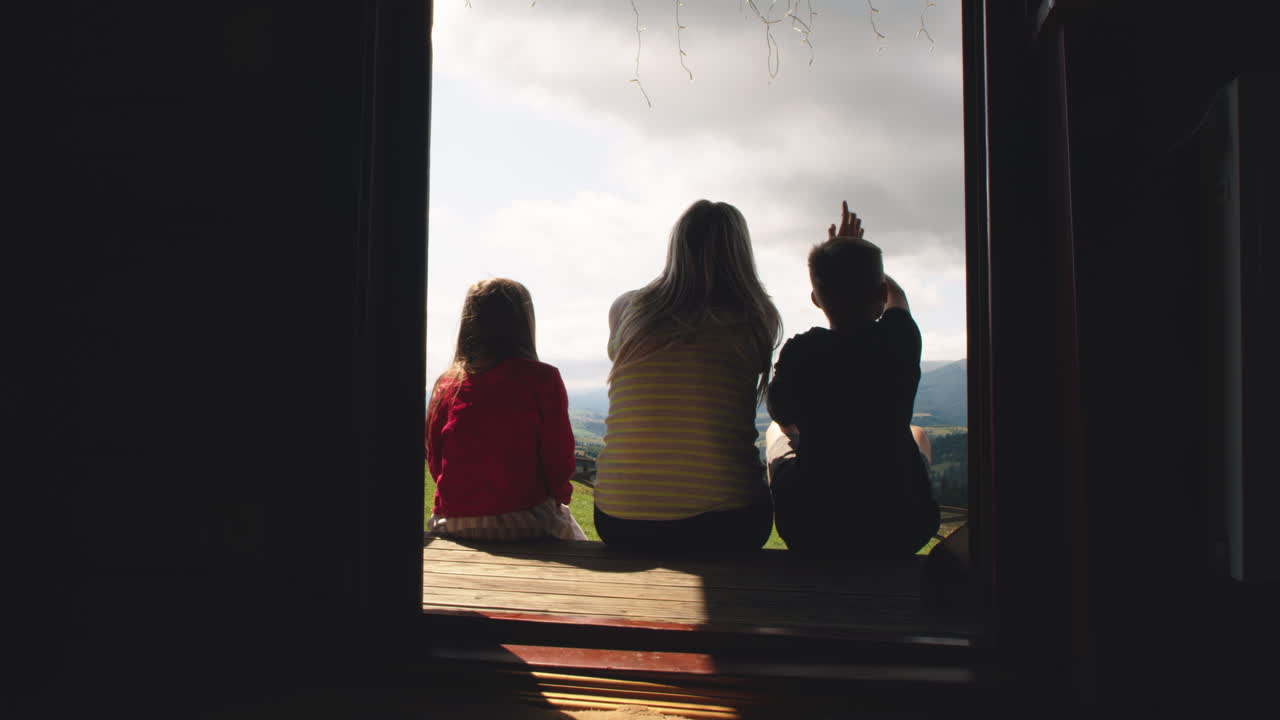 Family enjoying the view from a cabin