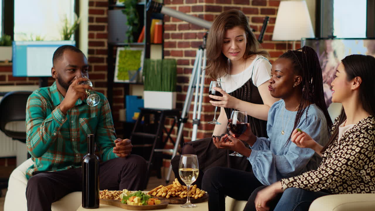 Diverse group of people socializing at home, enjoying appetizers