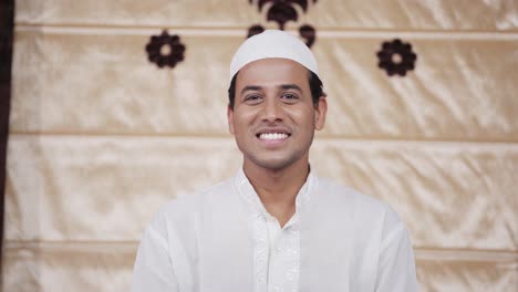 indian muslim man smiling and looking at the camera