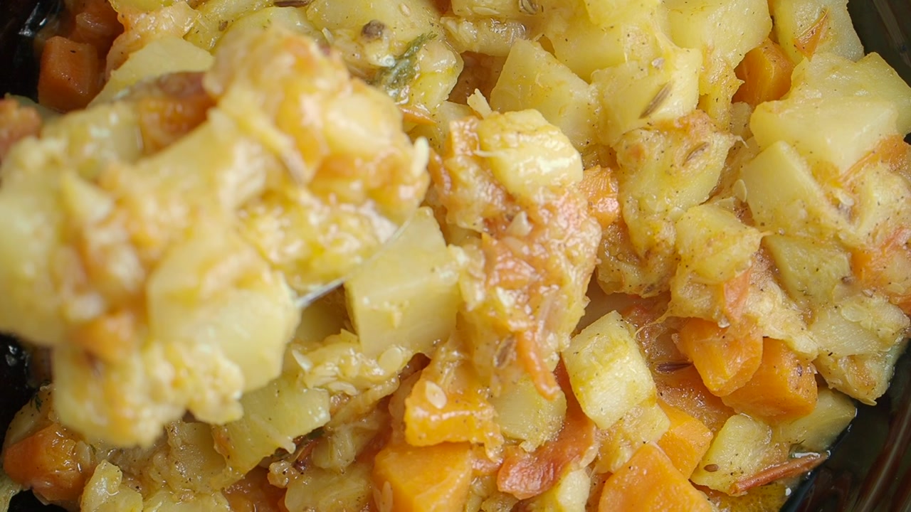 Close-up of a Spoon Stirring Potato and Carrot Curry