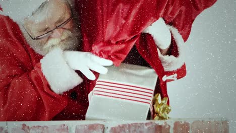 video composition with falling snow over santa trowing gifts in to chimney