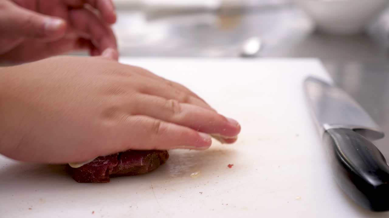 Preparing meat on cutting board