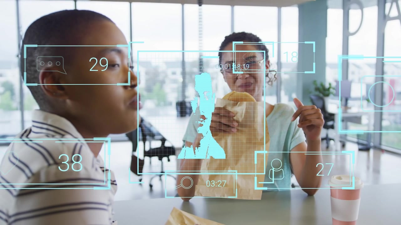 Animation of people icons over diverse business people eating