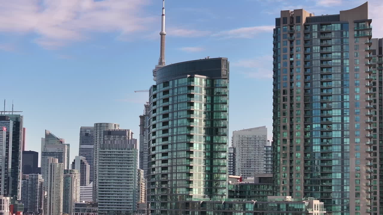Tracking aerial shot past the CN Tower and downtown Toronto.