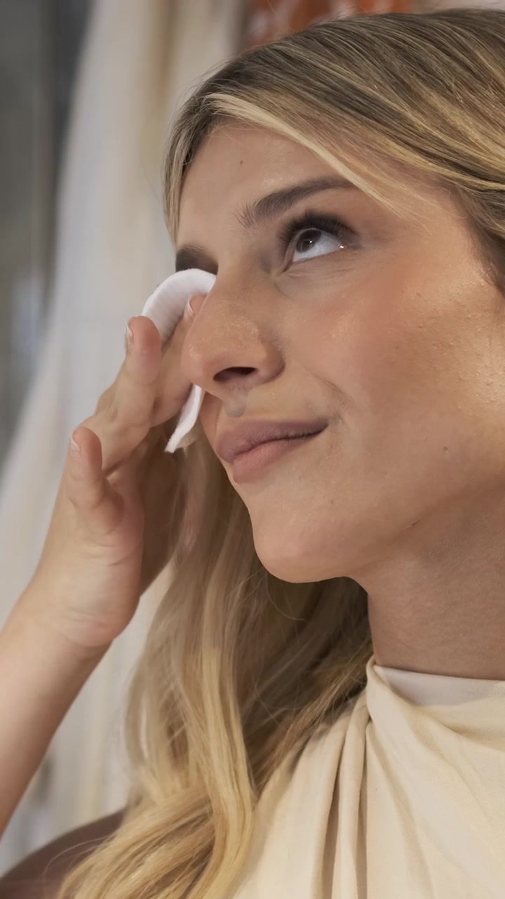 Young Woman Removing Makeup with Cotton Pad