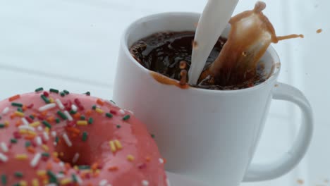 donut with coffee pouring in slow motion