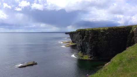 establishing shot of the beautiful green coast of scotland or ireland