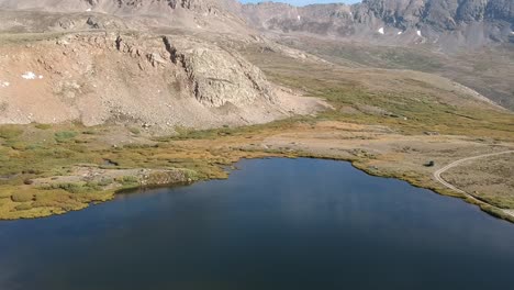 Aerial-views-of-Mosquito-Pass-in-Colorado-showing-fall-colors-on-large-meadows-with-touches-of-water-and-snow