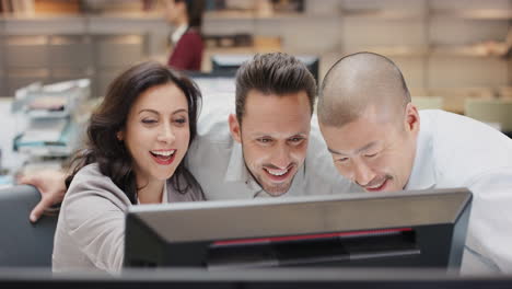 Diverse-team-of-business-people-working-late-brainstorming-around-computer-touchscreen