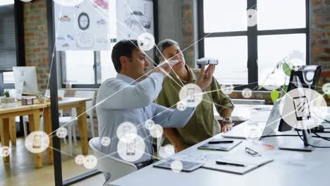 Animation-of-network-of-icons-over-caucasian-man-and-woman-discussing-over-car-model-at-office