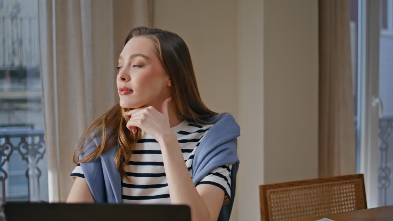 Relaxed student reading laptop studying online in home living room closeup