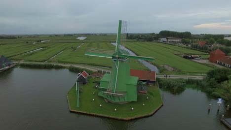 aerial shot of old windmills and fields in netherlands