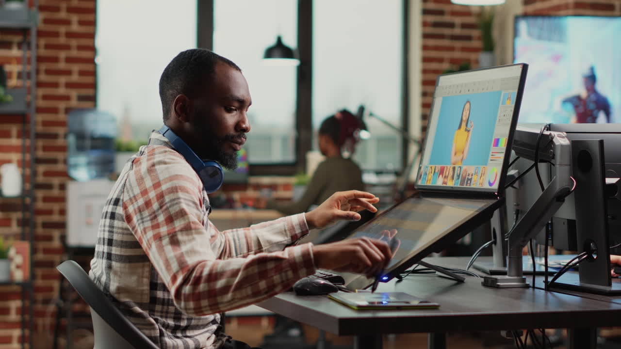 Young professional retoucher editing images on retouching software