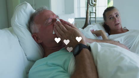 mature couple handling cold symptoms in bedroom, with animated health chart and tissue icon