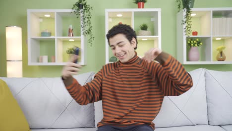 cute and funny boy listening to music on the phone.