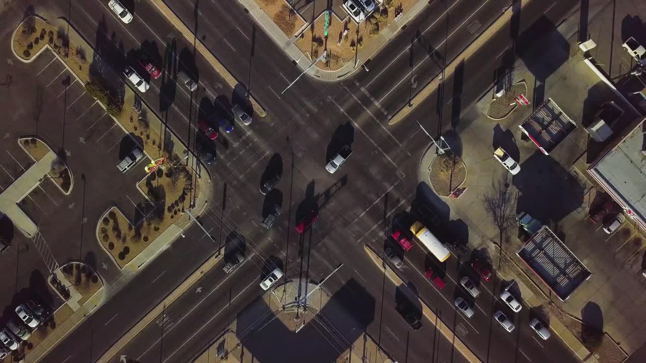 Drone flying overhead of a busy intersection in the evening
