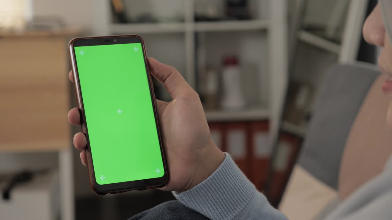 Close up image of smart phone mockup, woman holding phone with green screen