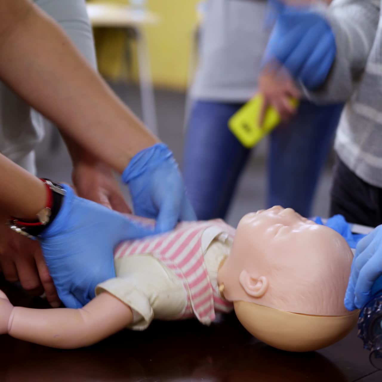 Newborn resuscitation on an infant dummy doll. First help medical class. Healthcare and education