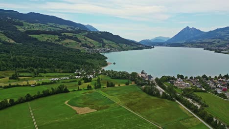 A-small-village-surrounded-by-a-lake-in-the-Swiss-Alps,-Brienzer-Rothorn-mountain-of-the-Emmental-Alps,-Switzerland,-Europe