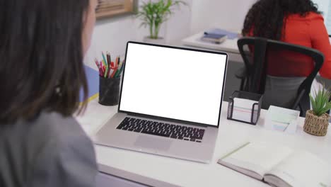 Biracial-businesswoman-using-laptop-for-video-call-with-copy-space