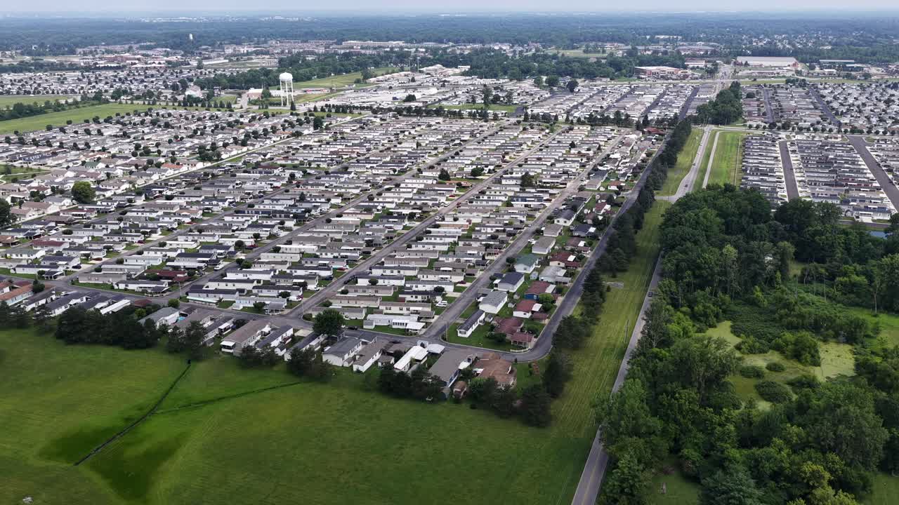 Overhead aerial of neighborhood streets in Indiana with lush green lawns and clean streets