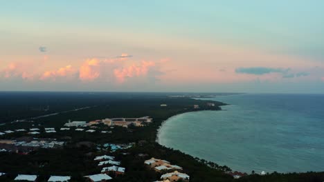 stunning aerial drone shot of a tropical mexican coastline line full of vacation resorts in riviera maya between tulum and cancun during a warm summer sunset