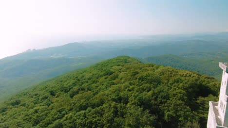 aerial view of mountaintop tower and forest