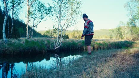 a man is casting bait into the creek - static shot